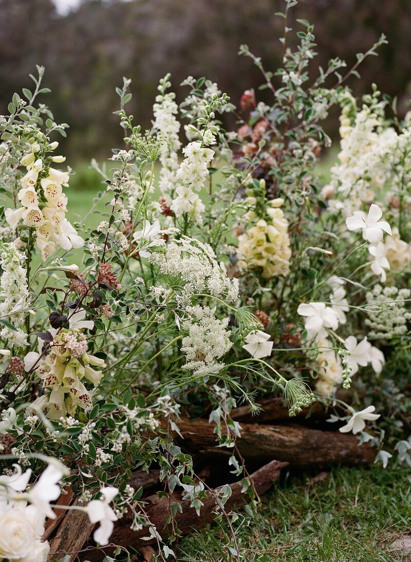 Loop flowers luxury wedding tablescape with yellow and pink florals with accents of burnt orange and slate blue