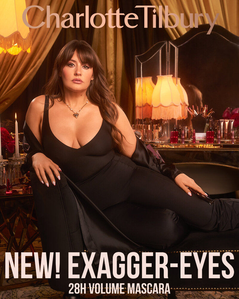 Charlotte Tilbury Exagger-Eyes 28H Volume Mascara campaign featuring Kirbie Johnson, lounging in a luxurious setting with glamorous makeup.