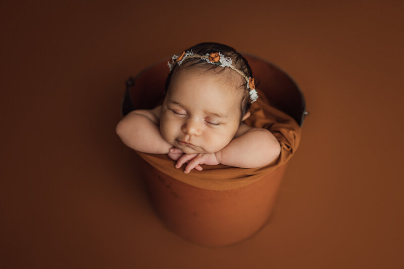 baby girl in bucket prop for studio newborn session in Tampa, Florida