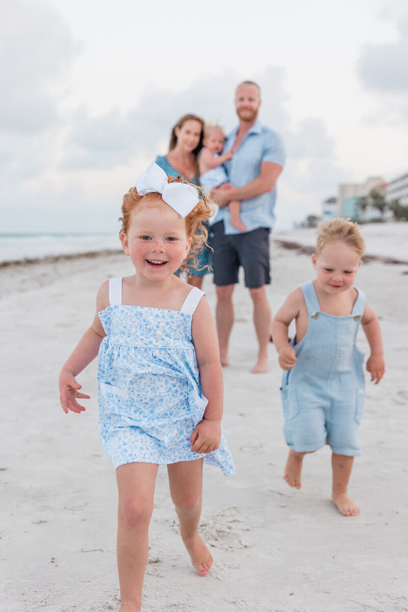 children running during family photo shoot on Indian Rocks Beach