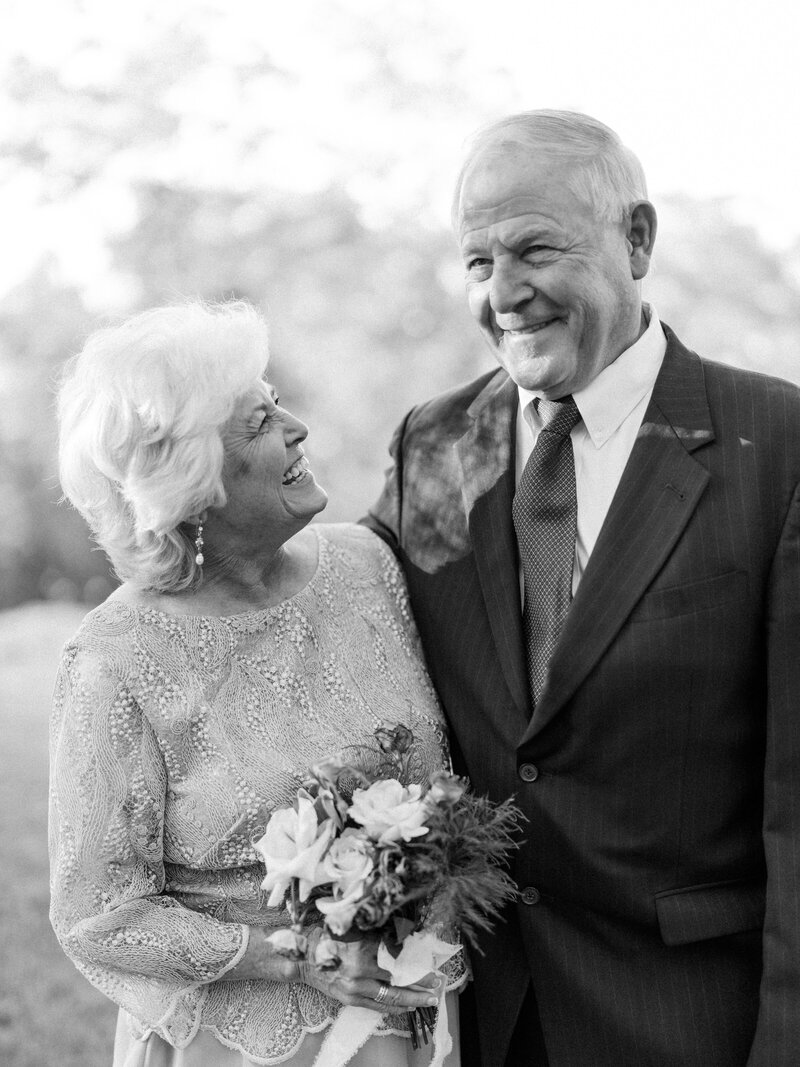 Bride and groom smile at camera