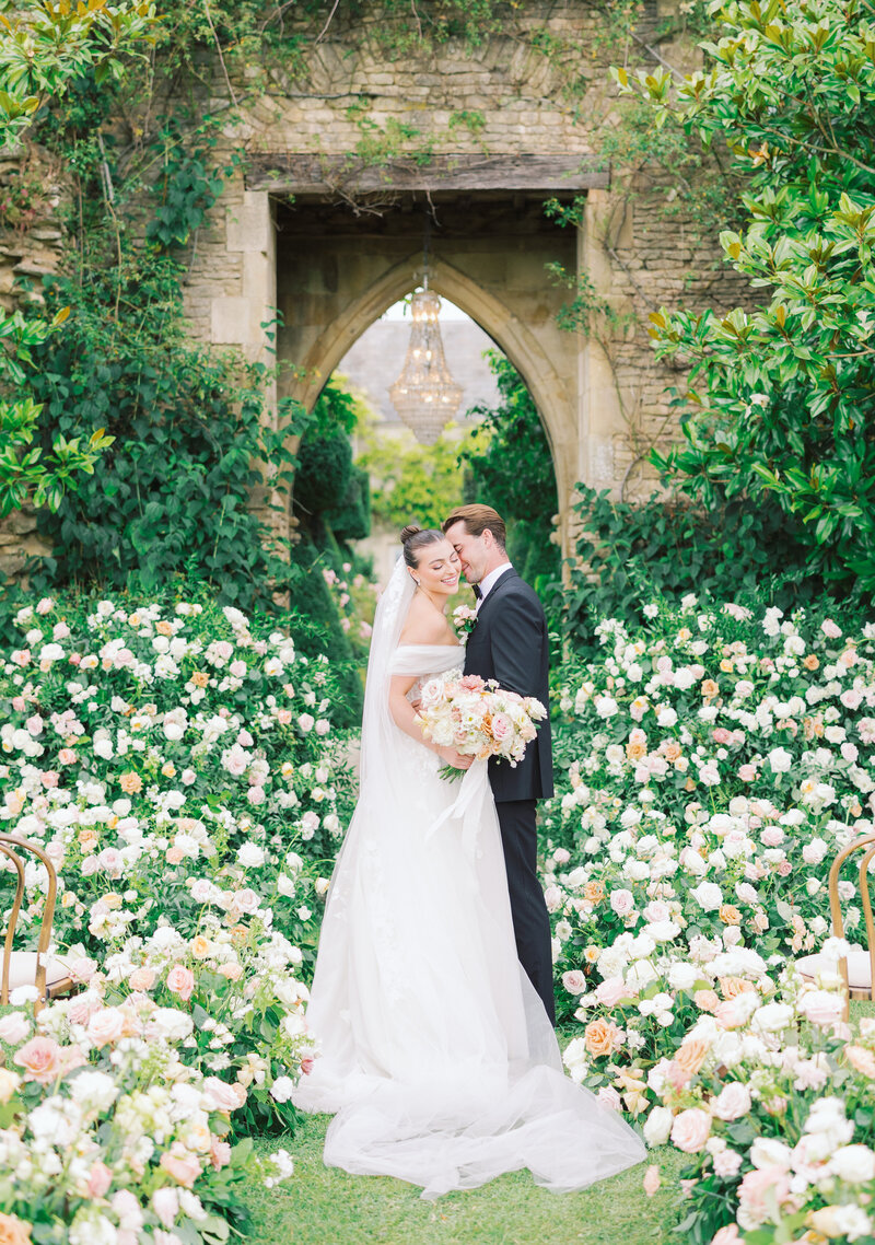 Bride and Groom embrace in sea of flowers
