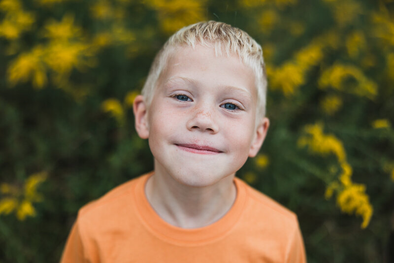 Close-up outdoor portrait of young boy smiling in Bonne Terre Missouri.