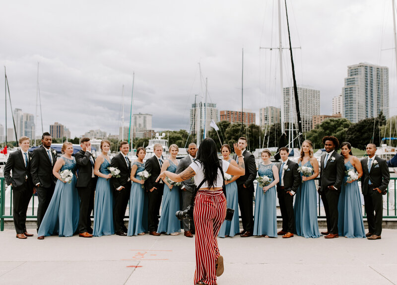 photographer directing a large bridal party for photos