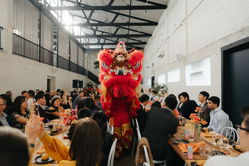 chinese dragon walking through the crowd at a Fitzroy Wool Mill Wedding