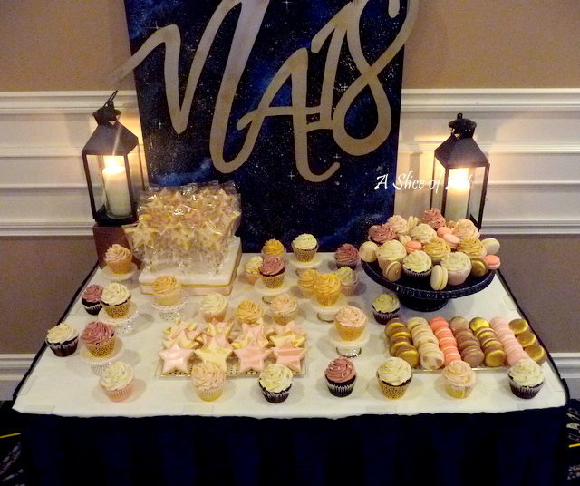 dessert table of macarons, cupcakes and sugar cookies