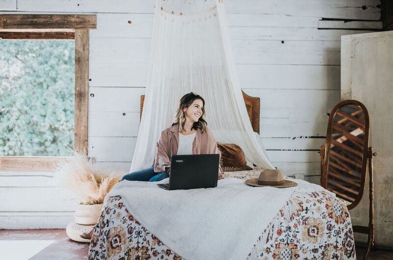 woman smiling while working on computer