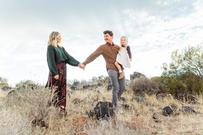 family walking in bushes for family photos in the fall