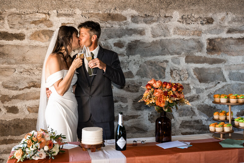 Bride and Groom Sharing a toast and kiss at the Vista house Mount Spokane, WA.