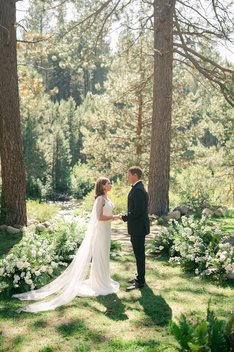 Lake Tahoe Bride and Groom hold hands during their wedding ceremony at Dancing Pines wedding venue.