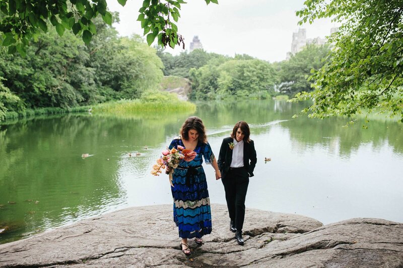 NYC central park elopement couple with blue dress along the water holding hands