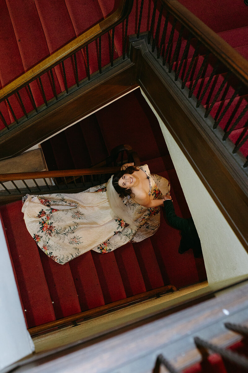 A bride looks up at photography during her wedding in Oakland Ca