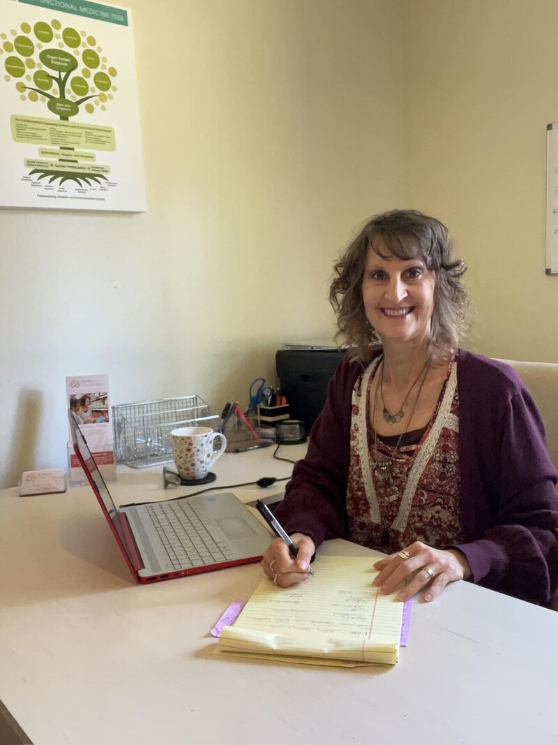 Penny in her office with a client