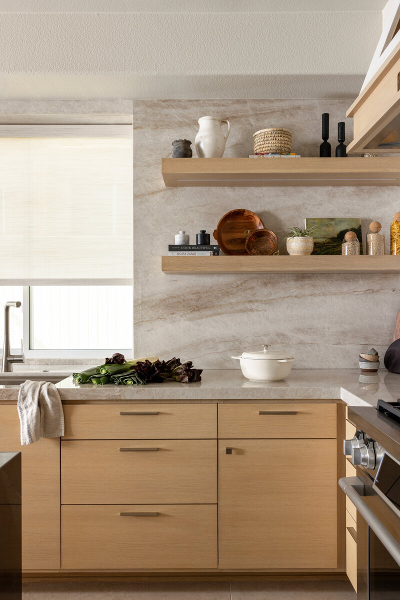 white oak kitchen cabinets with quartzite backsplash and floating shelves
