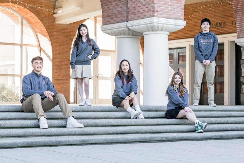 students posing on steps