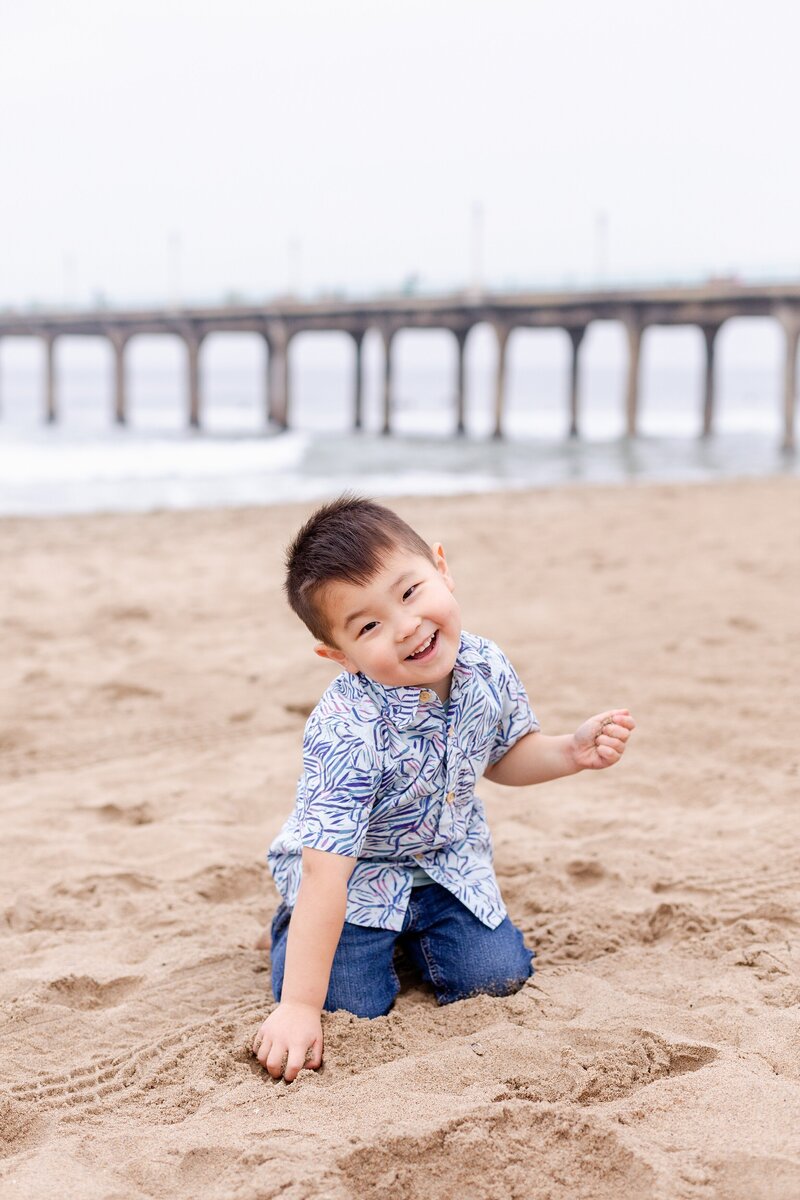 kid's portraiture of boy playing in the sand at Manhattan Beach, CA