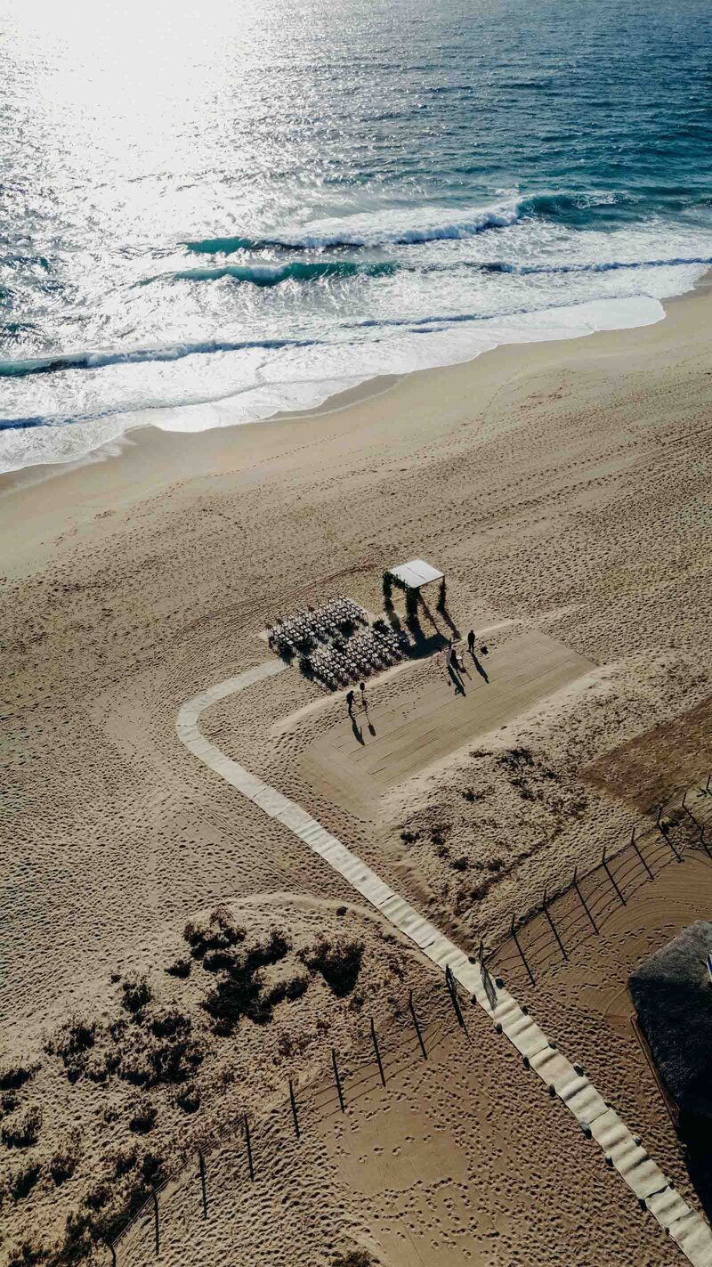 Seaside resort wedding Drone photo of the ceremony seating and shade