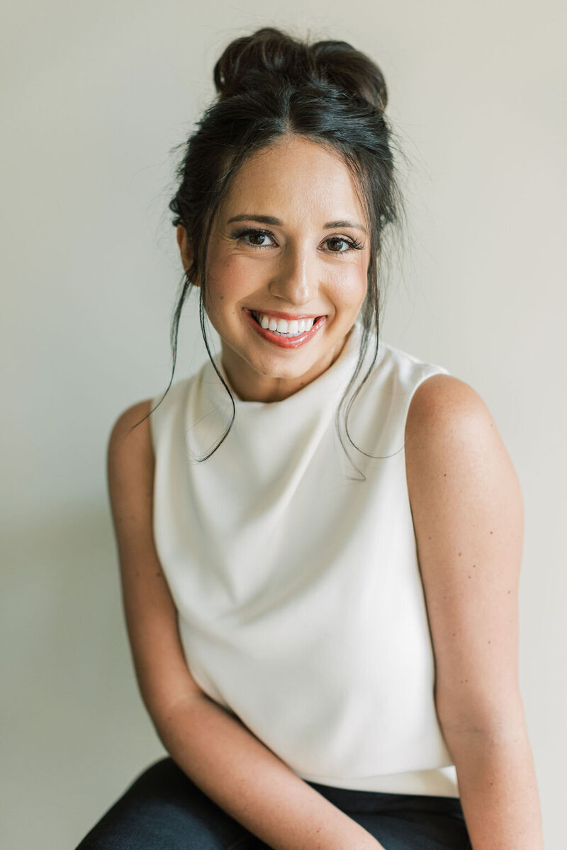 Woman smiles for camera for headshot portraits