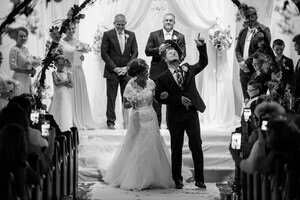 Newlyweds celebrate after wedding ceremony captured by St Augustine wedding photographer, showing joyful couple walking down aisle