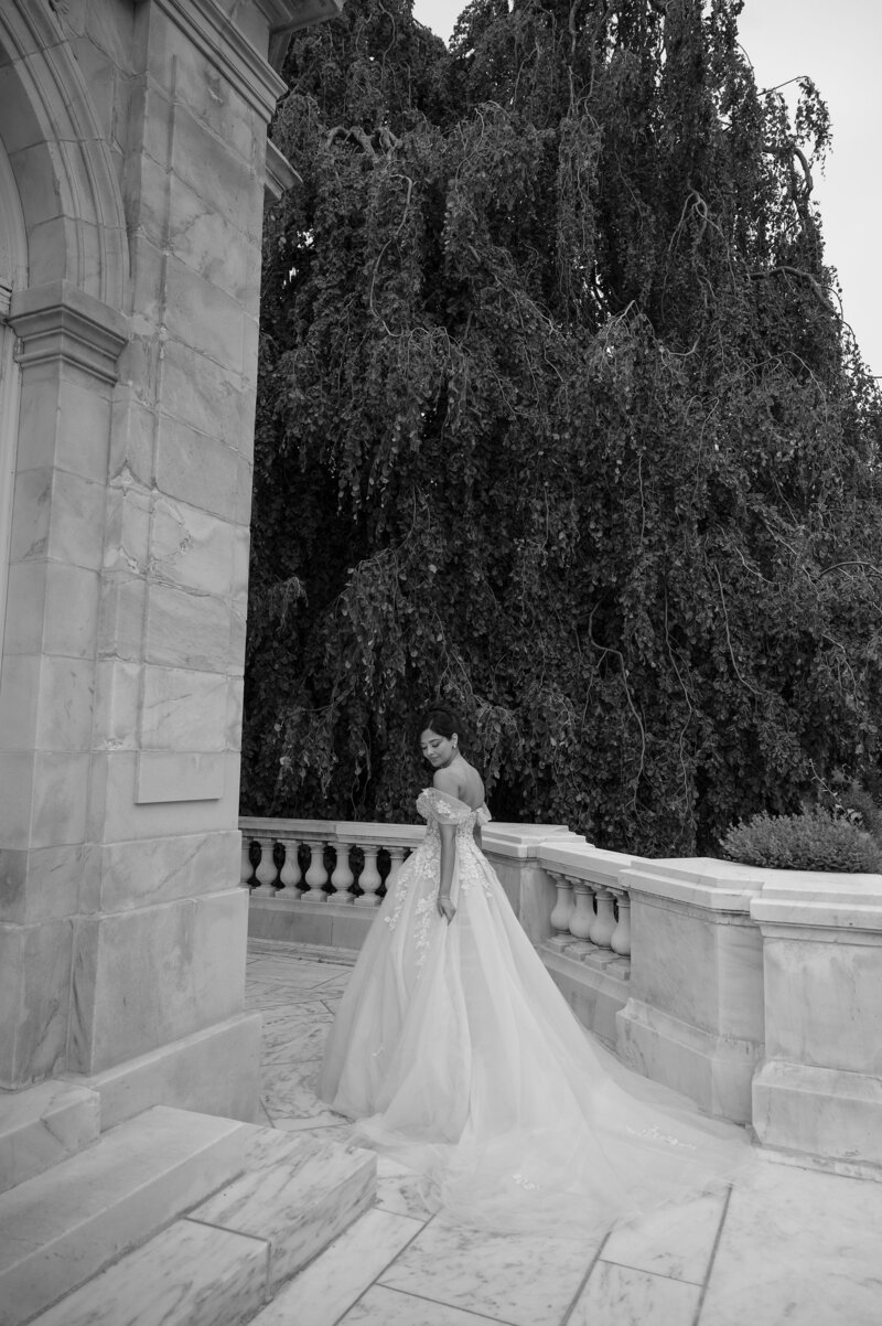 Bride poses in wedding gown on the grounds of the The Elms Newport. New England Wedding Photographer Deborah Zoe.