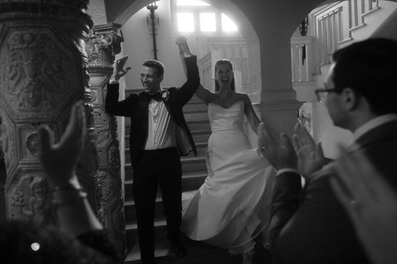 bride and groom going through bridal party tunnel