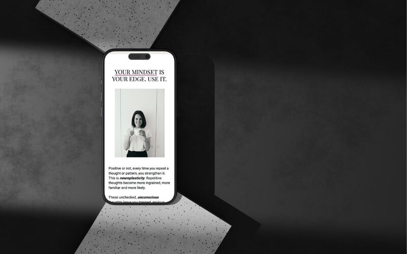 refreshed premium looking website redesign. Your mindset is your edge with image of Kaya Ramjee smiling holding a mug. Iphone screen with dark background