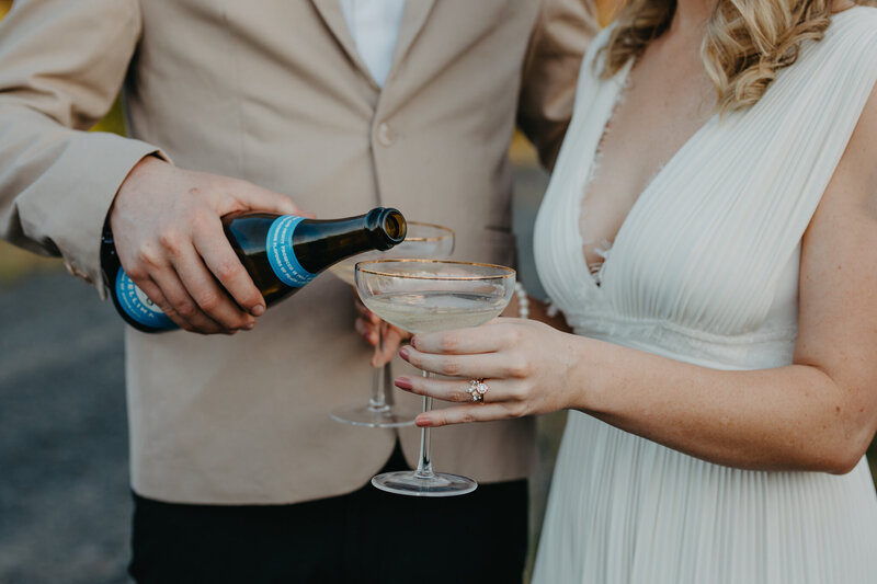bride and groom toasting with a glass of champagne