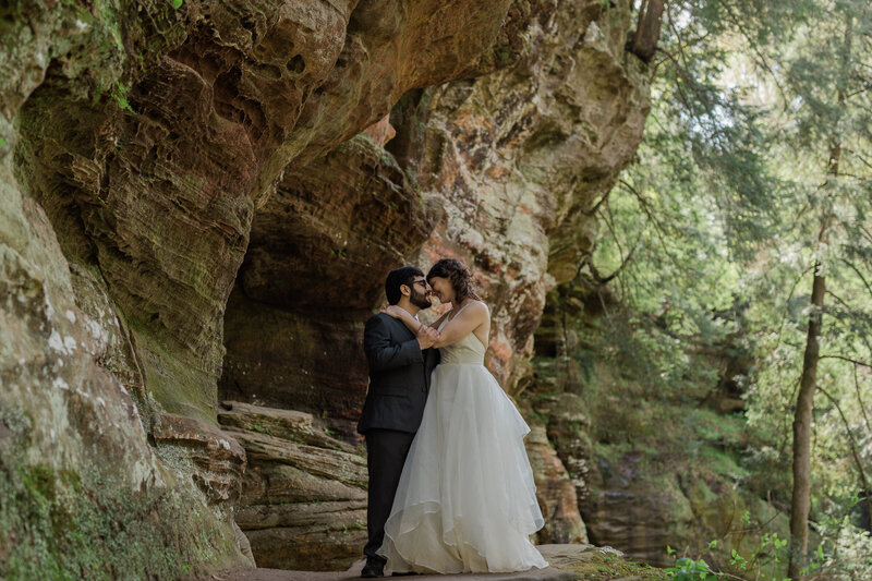 Interracial couple look at each other in Hocking Hills, Ohio