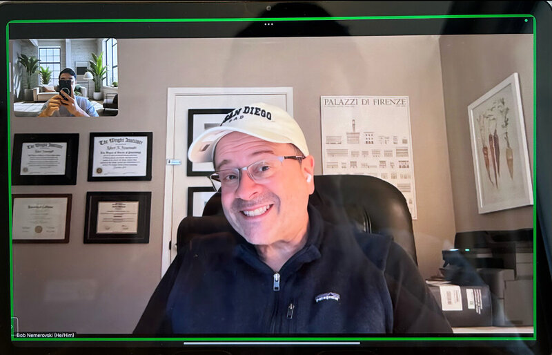 Smiling man wearing glasses and a cap during a virtual 1-on-1 Japanese coaching session via Zoom
