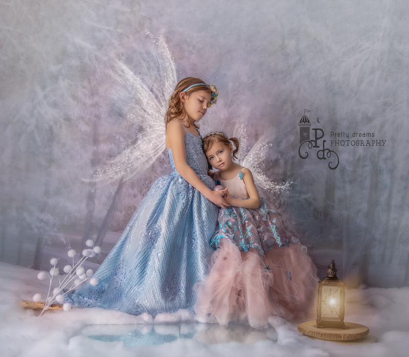  "Children transformed into enchanting fairies, captured in a whimsical, fantasy-inspired portrait session surrounded by soft lighting and delicate props in Ottawa."