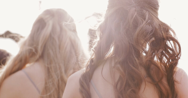 Wedding film still image of Wedding bridesmaids' hair flowing in the wind at a California winery wedding.