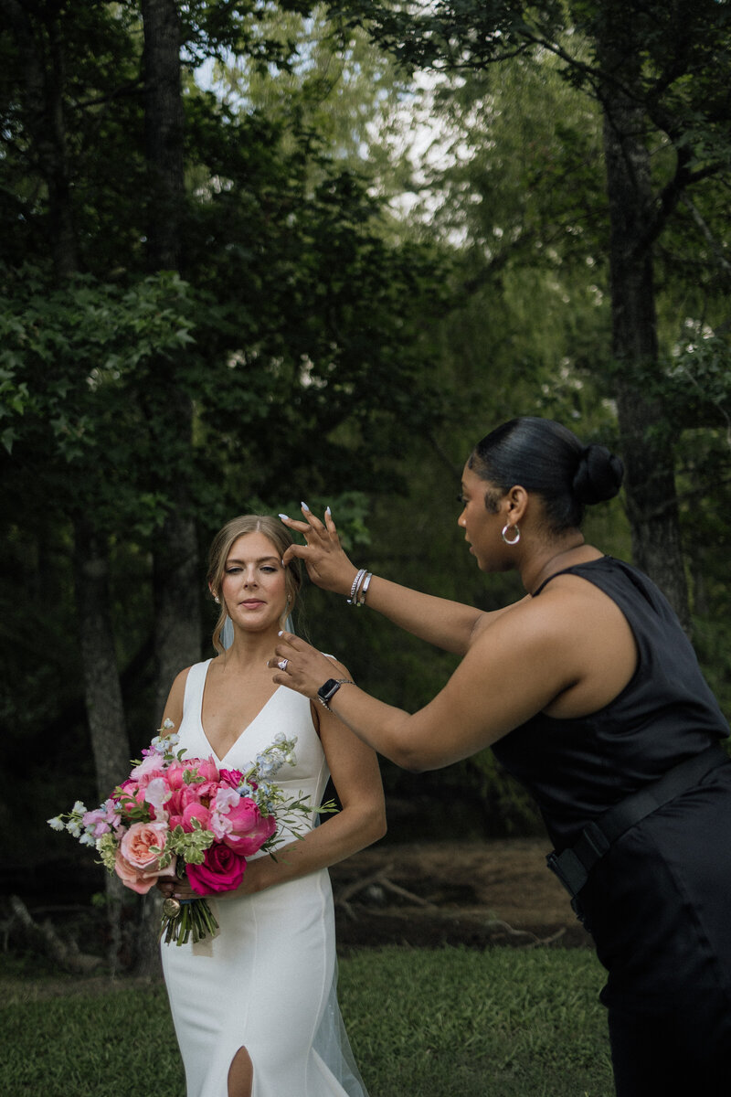 Wedding planner in Houston smiling with a bottle of champagne.