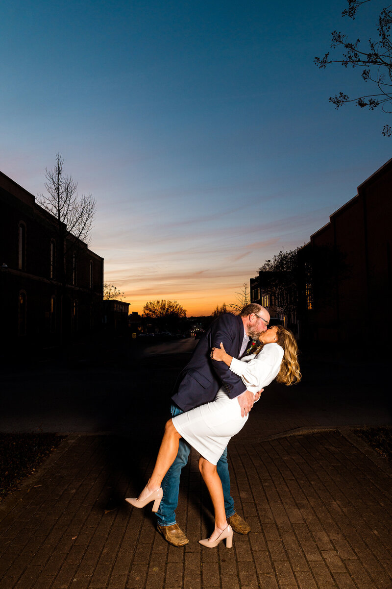 Couple dipping and kissing at Sunset in downtown Murfreesboro during their elopement