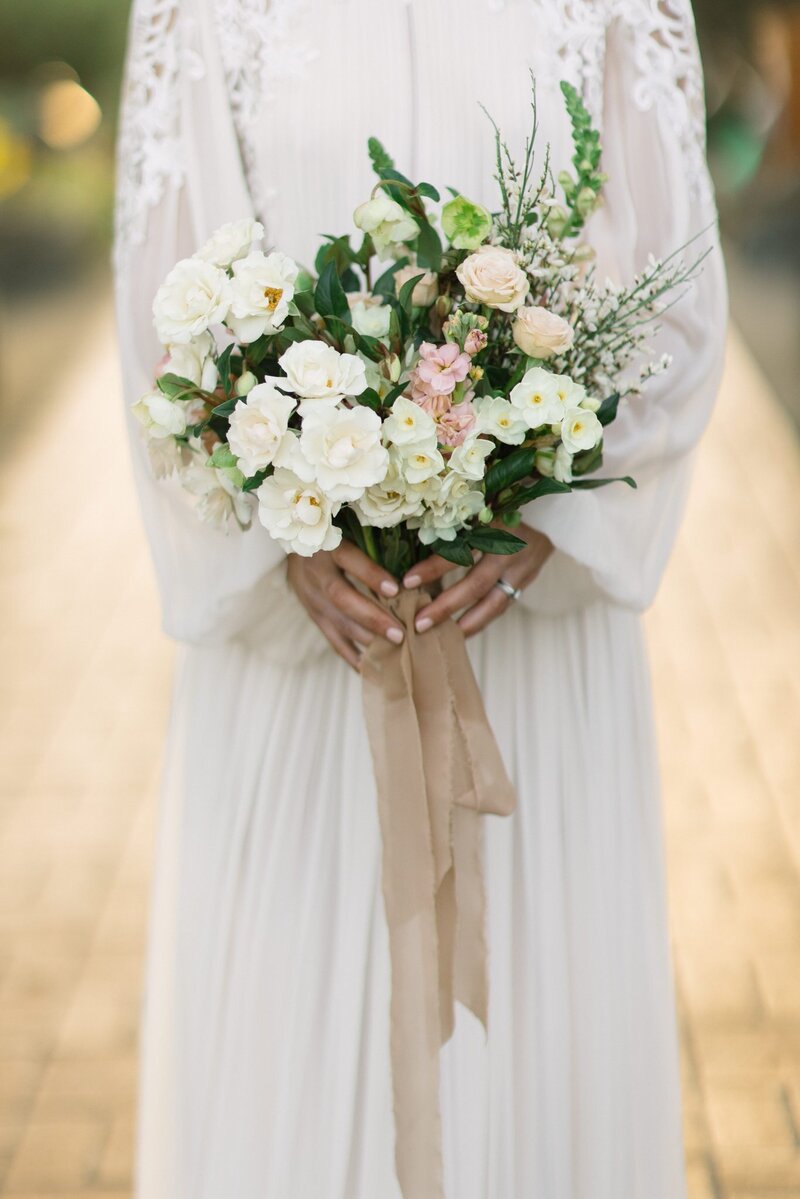Bride carrying bouquet created by Carmel Gardens florist for a wedding at The Club at Pasadera 