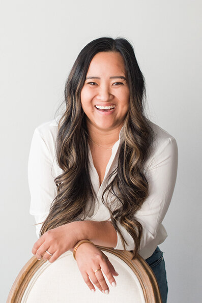 Casual headshot of photo business owner laughing