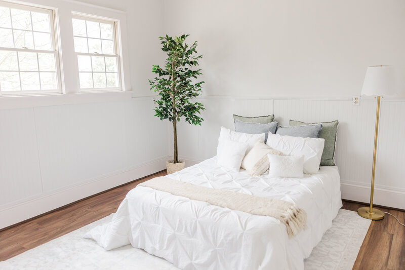 a room with a cozy bed for newborn photography