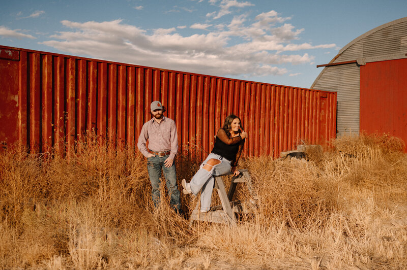 A couple in front of a red storage container