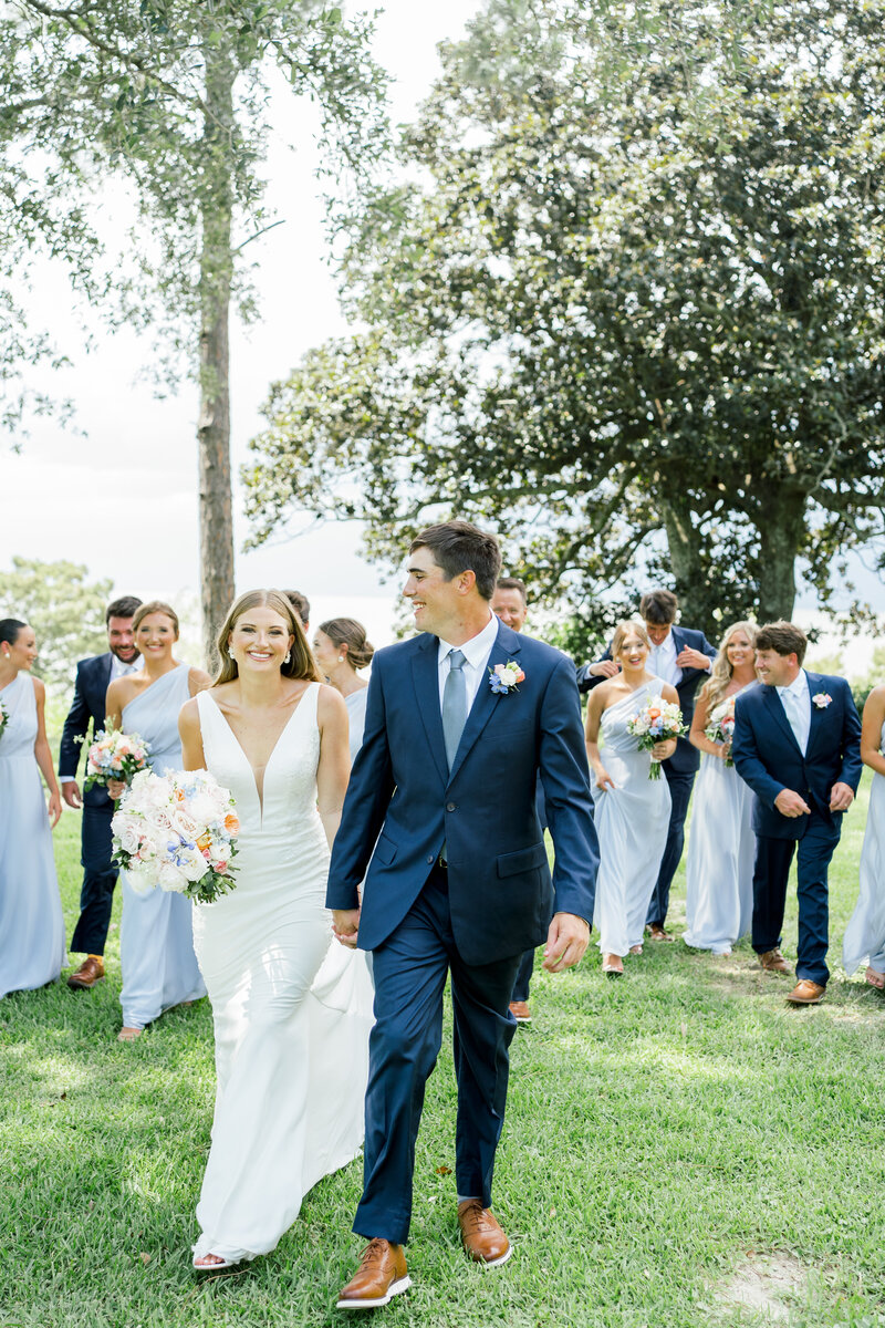 bride and groom walking while holding hands