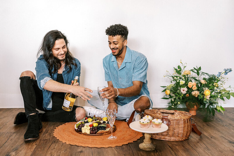 A couple enjoy an indoor picnic, representing a styled photoshoot by Among the Oaks. 