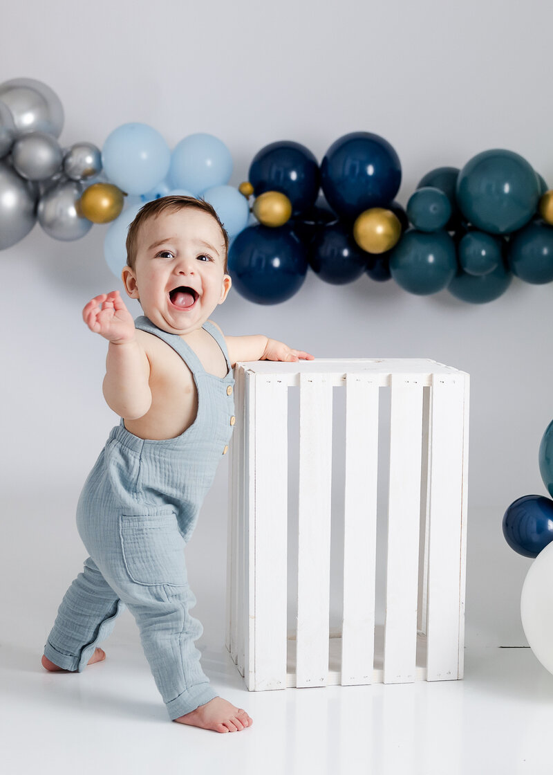 Light and airy lifestyle portrait of a baby at a 1st birthday cake smash photo session at Allison Reilly's Union County, NJ photo studio.