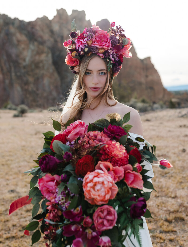 A striking bridal portrait featuring a dramatic floral crown and bold colors, perfect for adventurous photographers inspired by the Pacific Northwest.