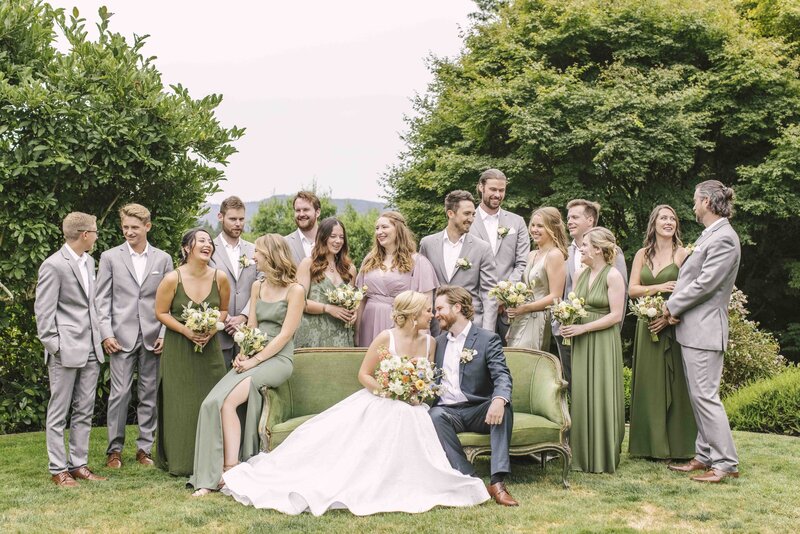 bridal party sitting on green couch