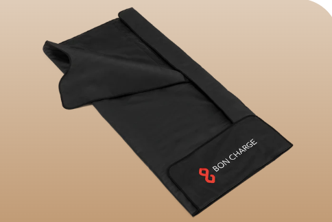 Hands holding a glass of water on top of a white table.