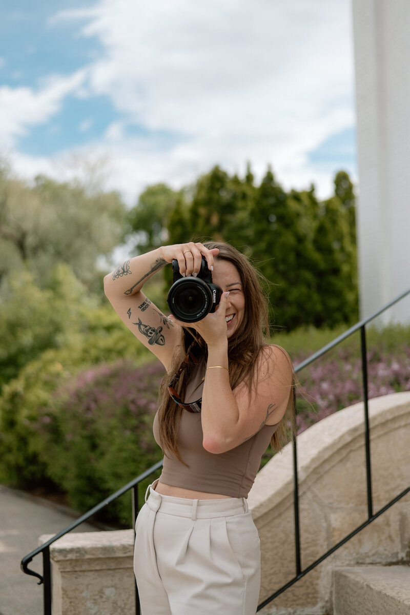 woman  holding camera and laughing