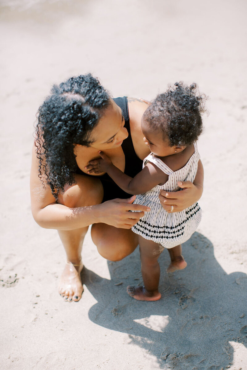 image of a woman on a beach with her baby on a website for therapy intensives for Moms in Massachusetts and Texas