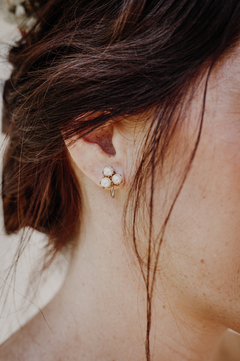 bride wearing three pearl earings