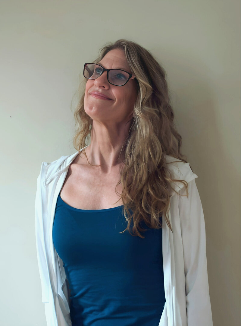 Julia, supportive midlife fitness coach glancing up