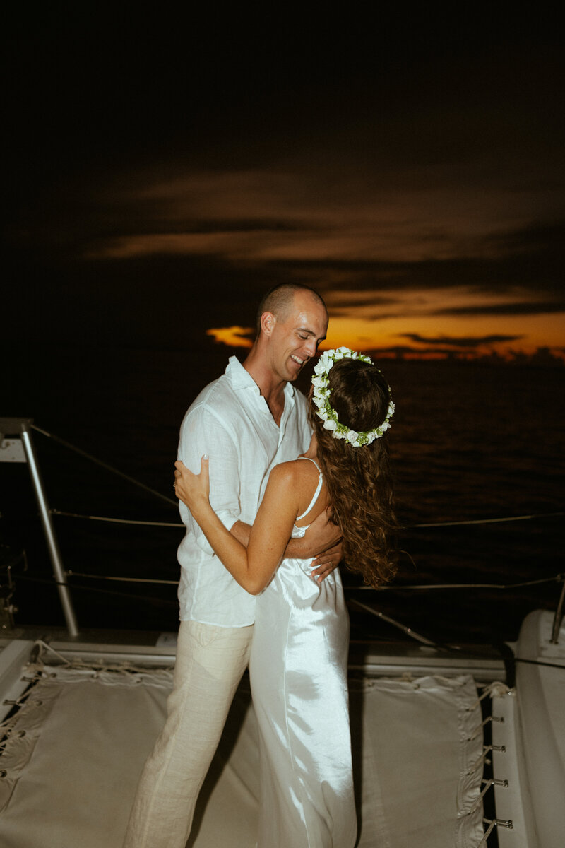 bride and groom dancing on boat