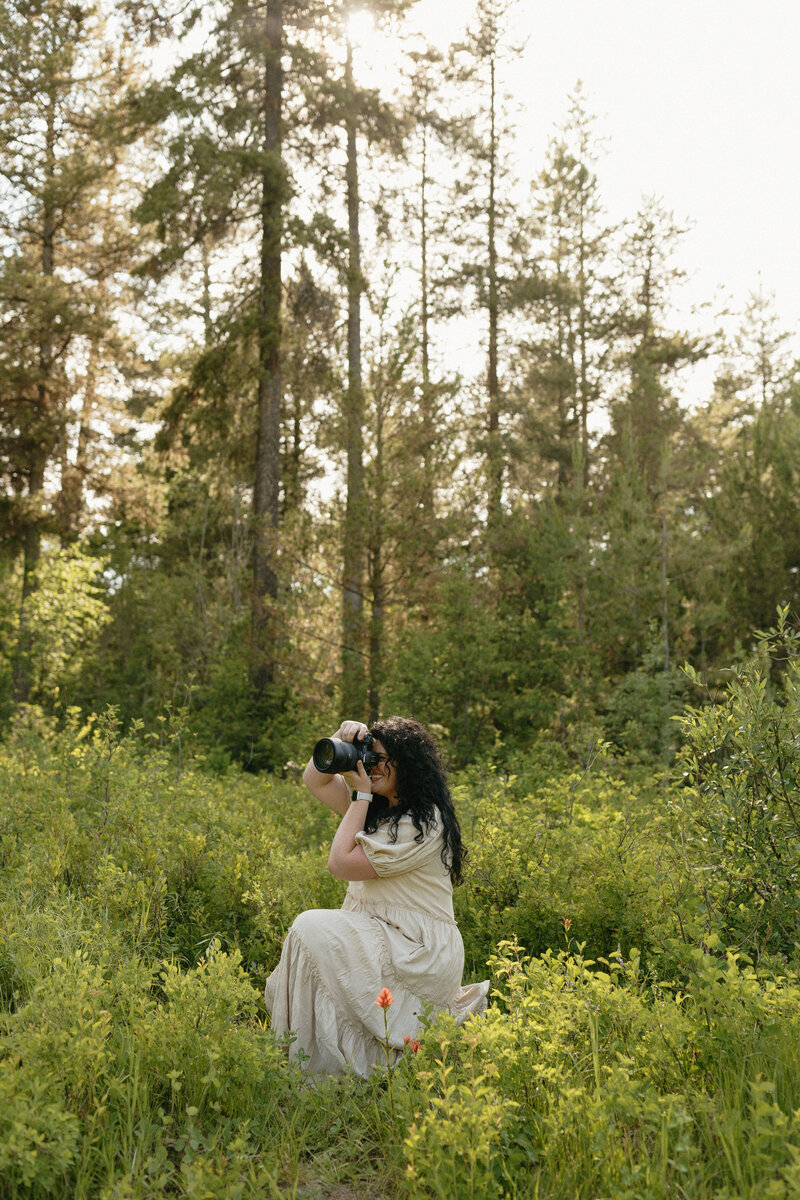Candid, dreamy portrait of a girl outside in the snow. She has her hand lightly touching her face and she is looking up towards the sky.