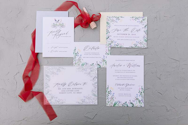 garden themed wedding invitations with flowers, butterflies, and wildlife
